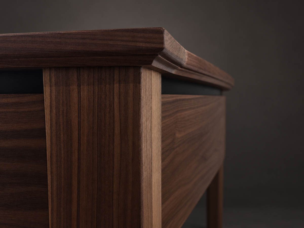 Close-up of SIEGE American walnut tabletop edge, apron and leg