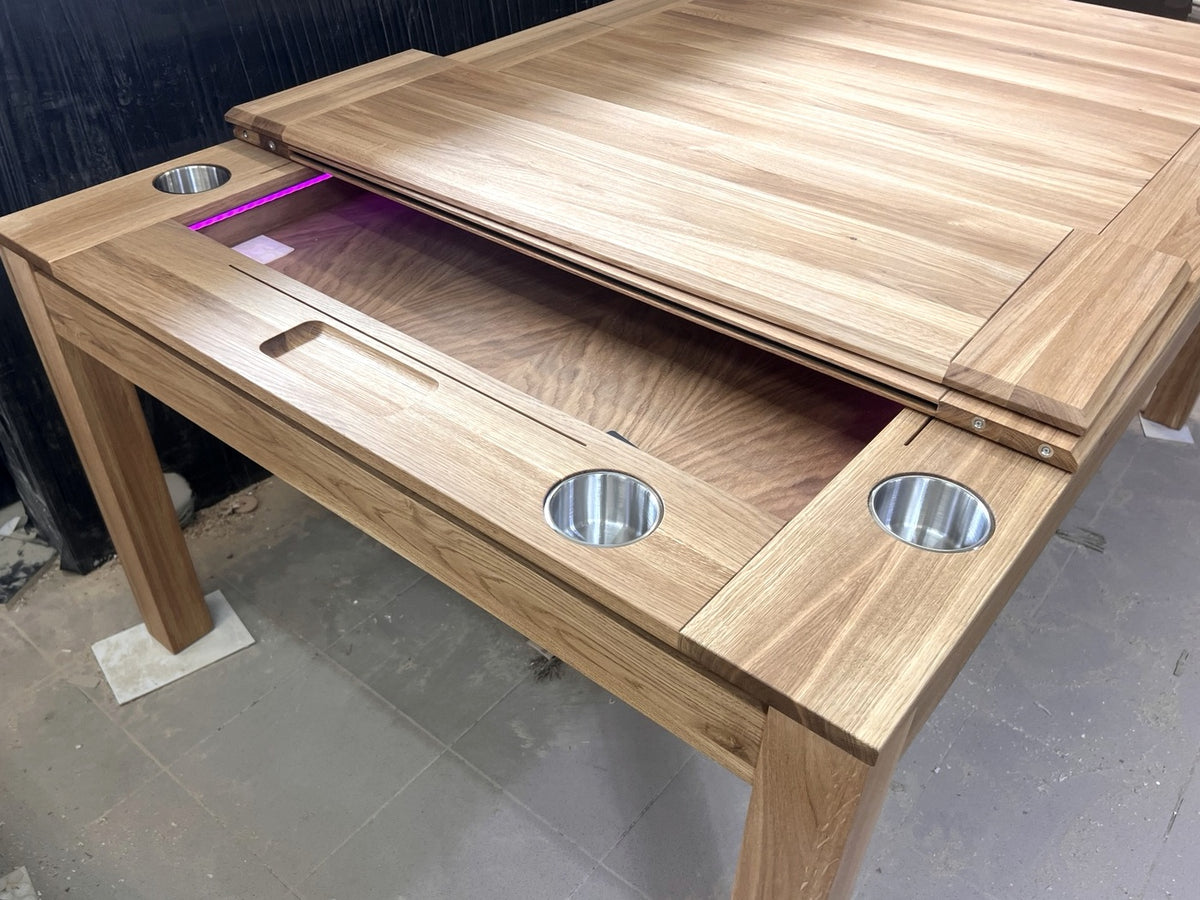 Close view of the solid oak Sojourn sliding dining top, recessed play area, LED lighting and cup holders